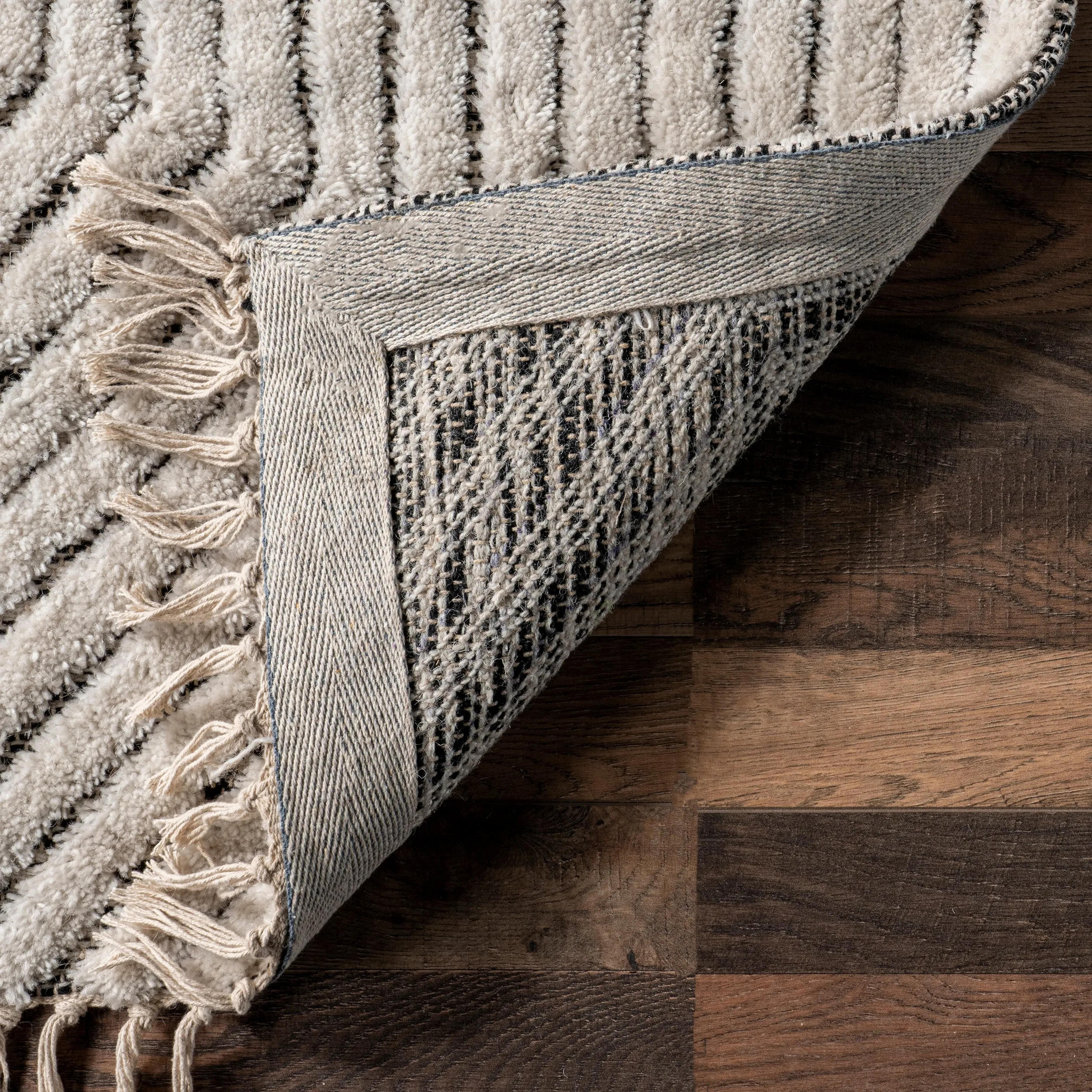 Sherrell Modern High/Low Tassel Area Rug